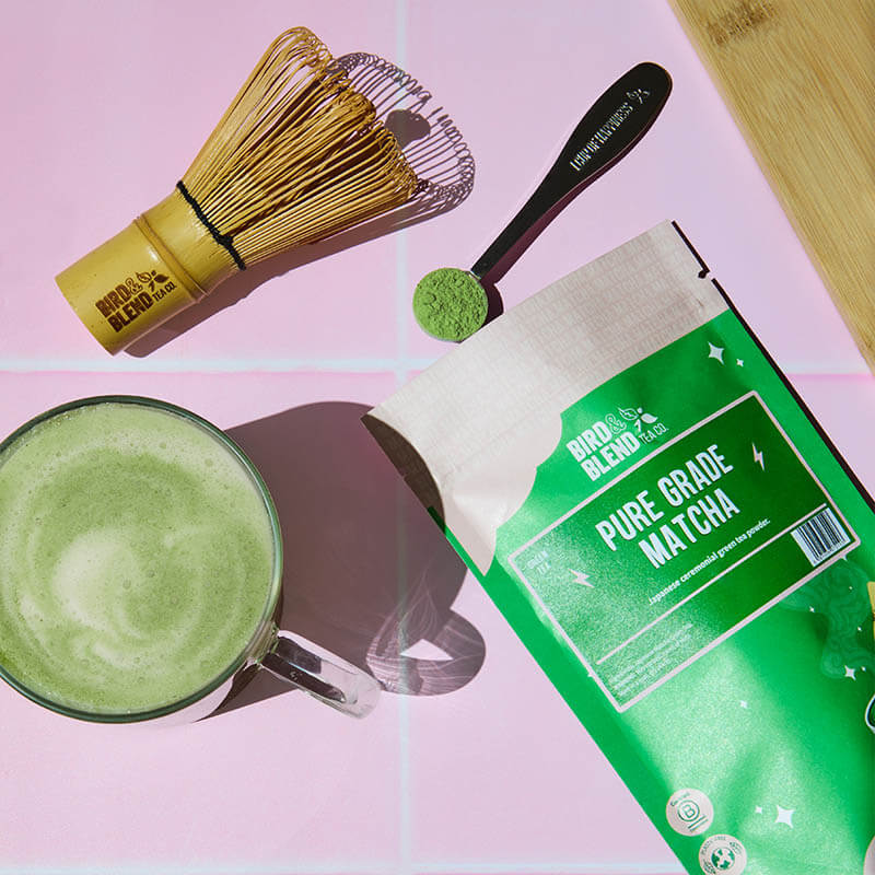 matcha pouch with matcha latte, whisk and tea spoon